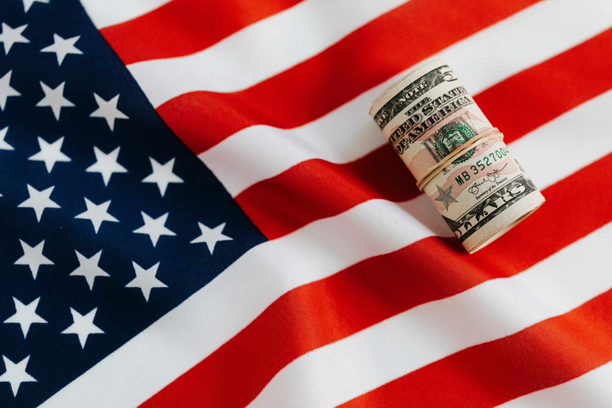 American flag with money on top.