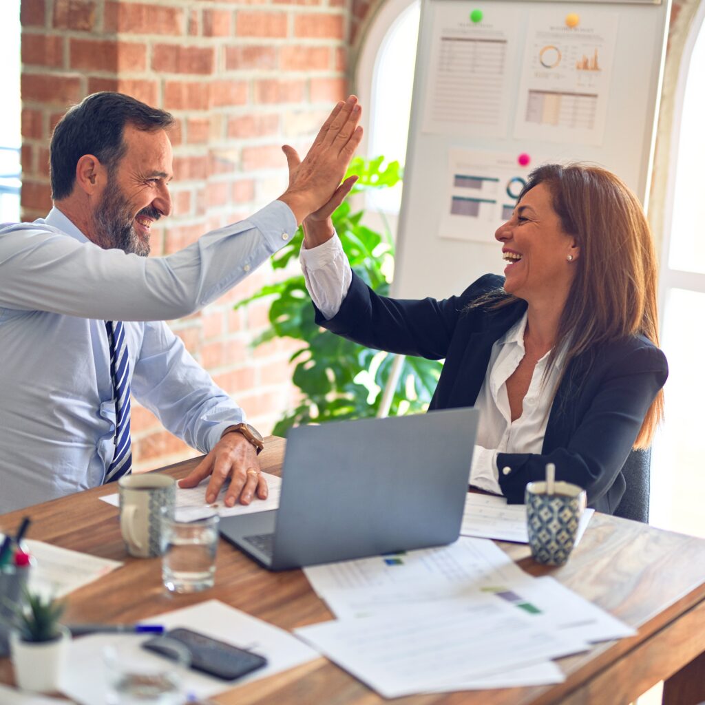 Man and woman celebrating their LLC holding