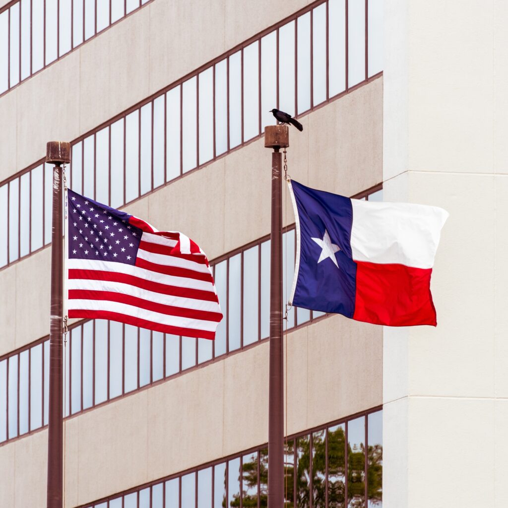 Two flags: one from the US and another of Texas