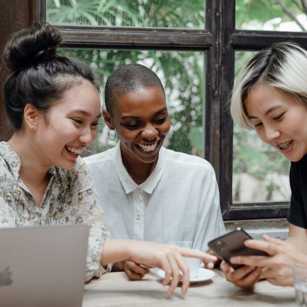 Three women talking about bank compliance