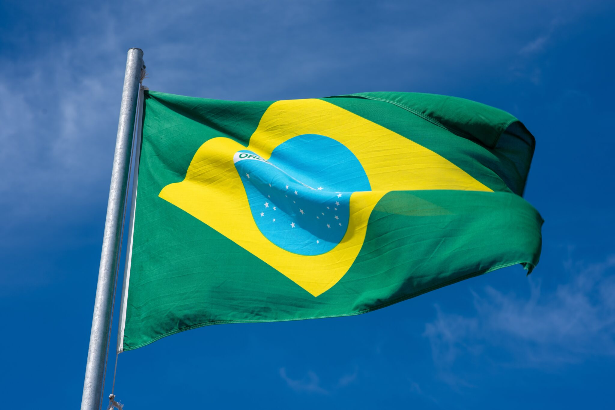 Brazilian flag against clear blue sky