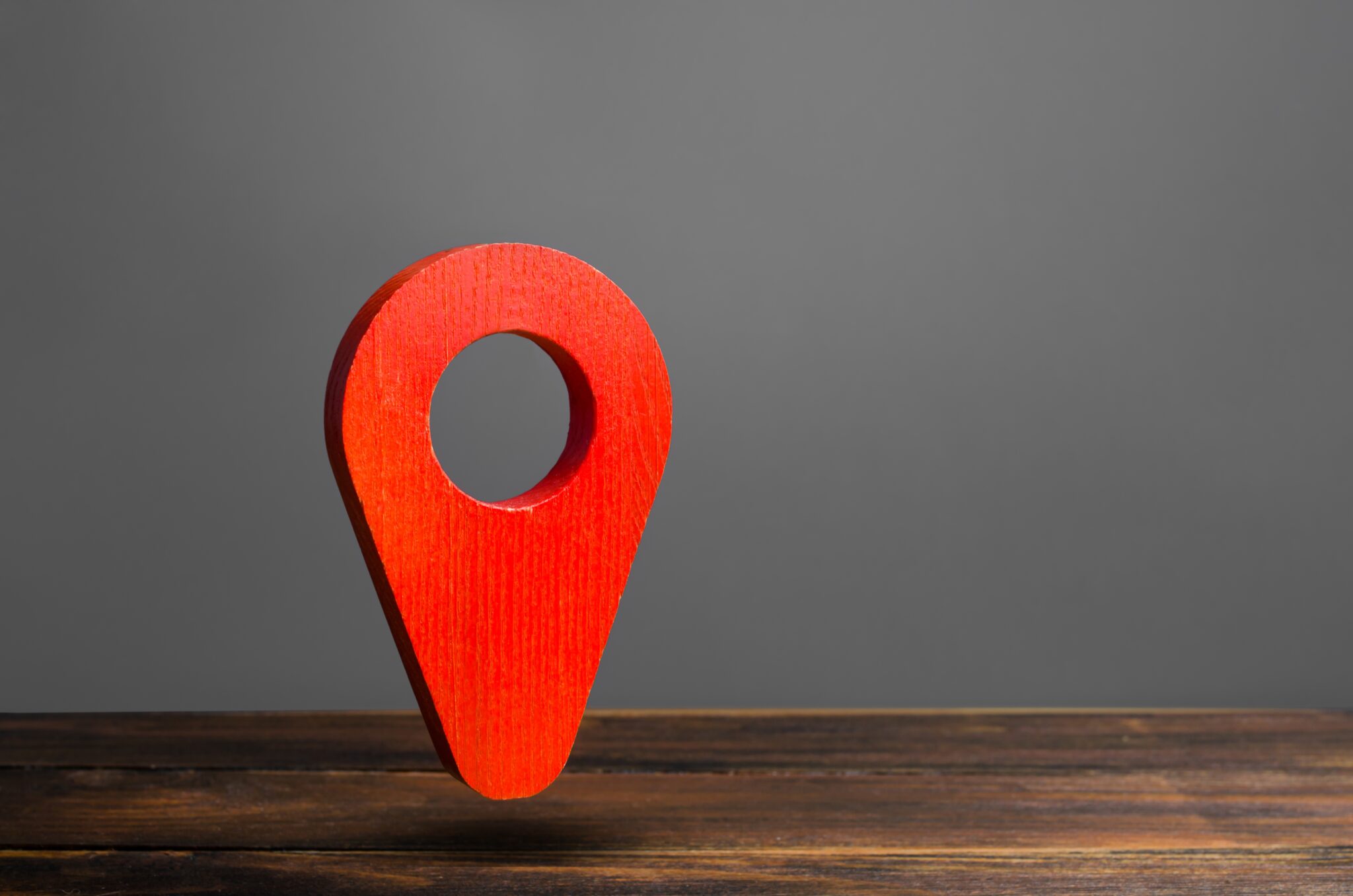 Red pin pointer location on a gray background. Concept of navigation. Tourism and travel. Logistics and the construction of optimal routes. Interesting places and attractions