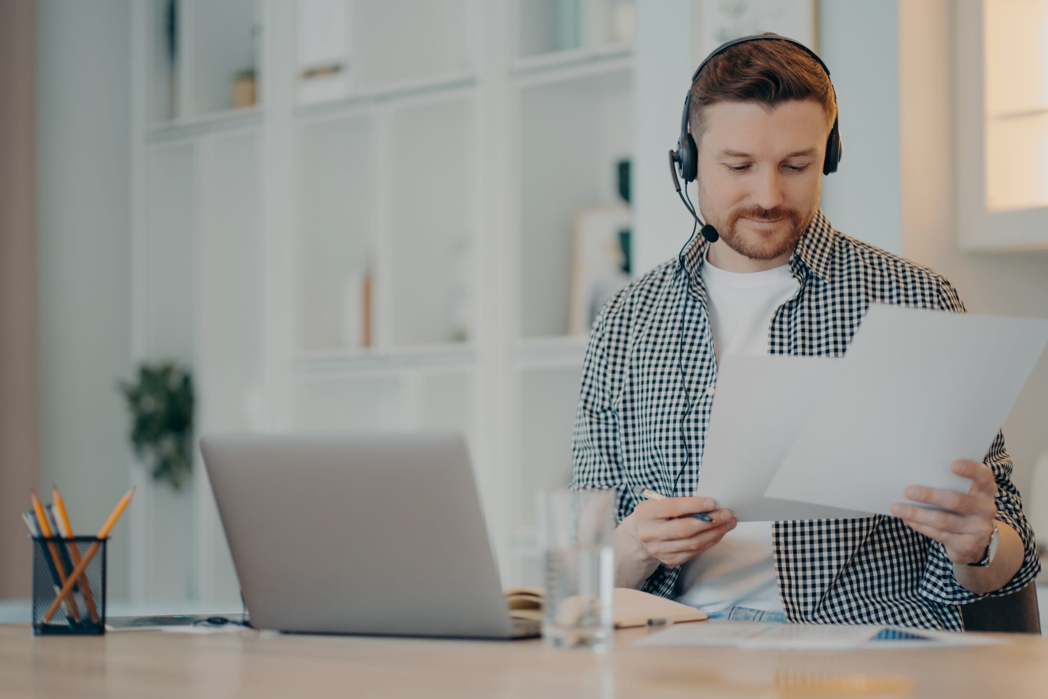 Man with headphones holding an LLC registration form.