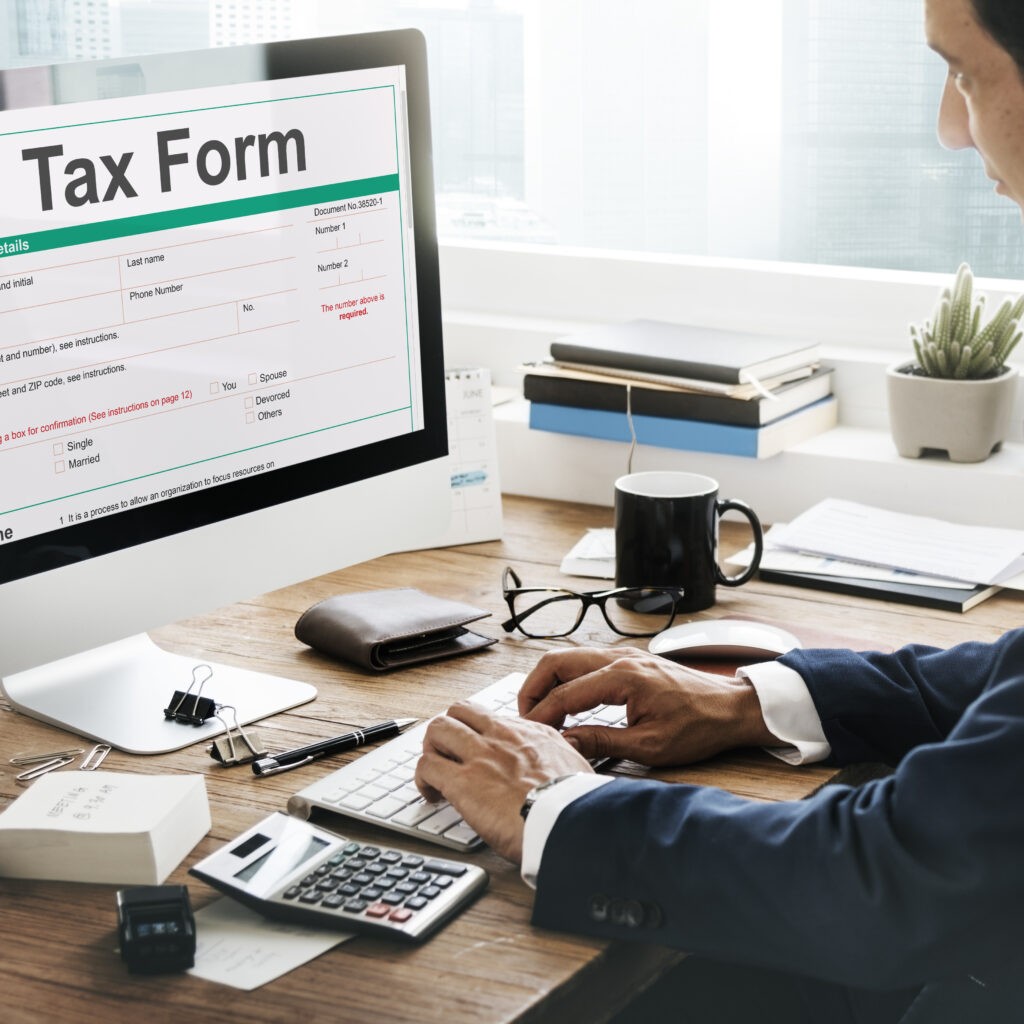 Man on the computer filling out a tax form