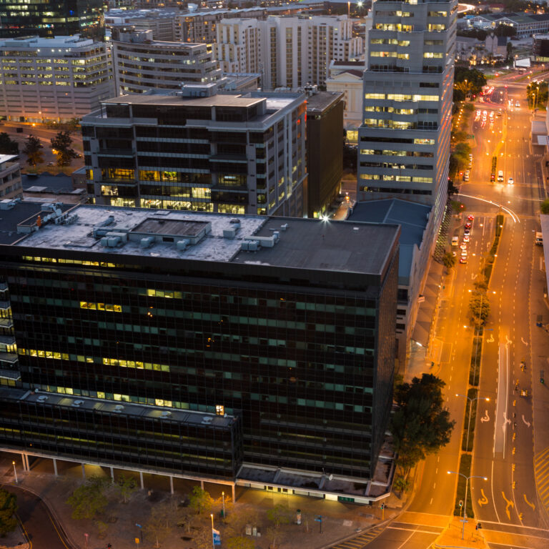 Aerial view of streets and office building in business district at night